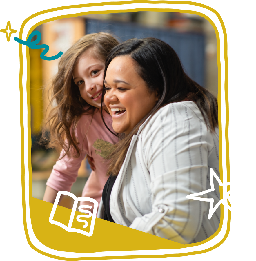 Literacy specialist smiling while tutoring a young student during reading instruction